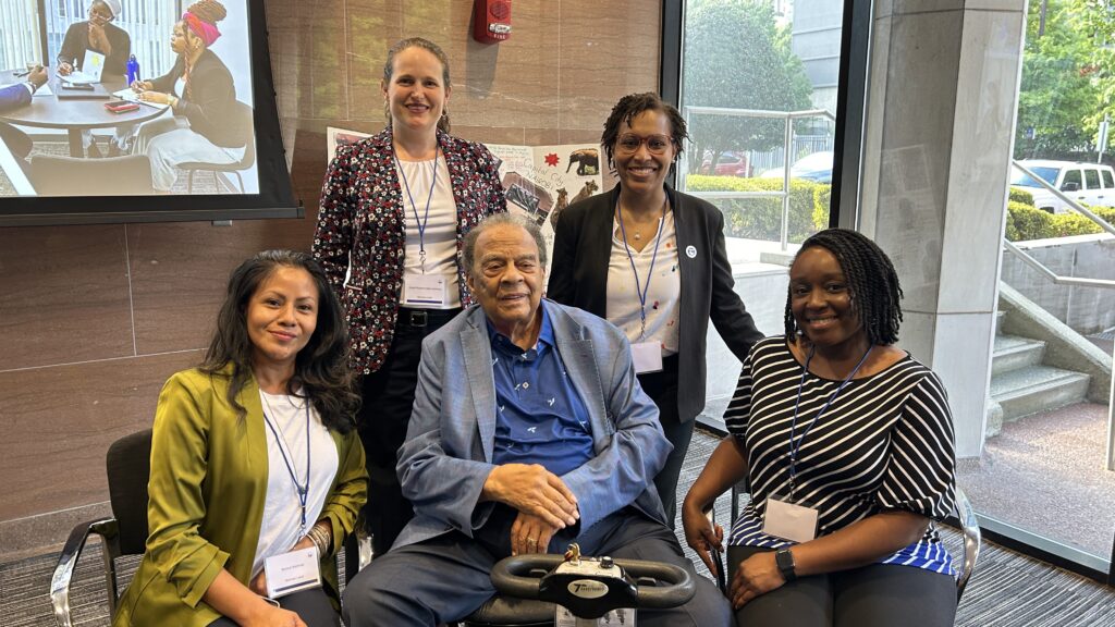 Ambassador Andrew Young pictured with four staff persons 